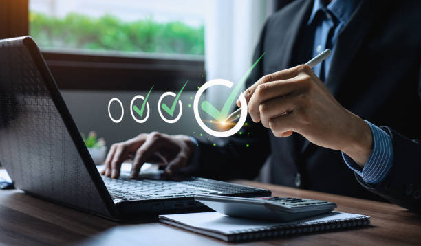 istock Business performance checklist, businessman using laptop doing online checklist survey, Check marks on checklist and Filling online form or answering questions. evaluation, online survey, online exam. 1498568369