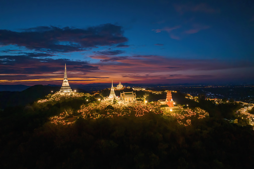 Aerial view by drone during twilight over Phra Nakhon Khiri Historical Park It is decorated with beautiful lights, commonly known as Khao Wang. summer palace, Mueang Phetchaburi District, Phetchaburi.