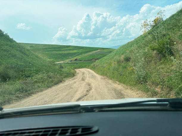 istock car descending from mountain on dirt road 1498574958