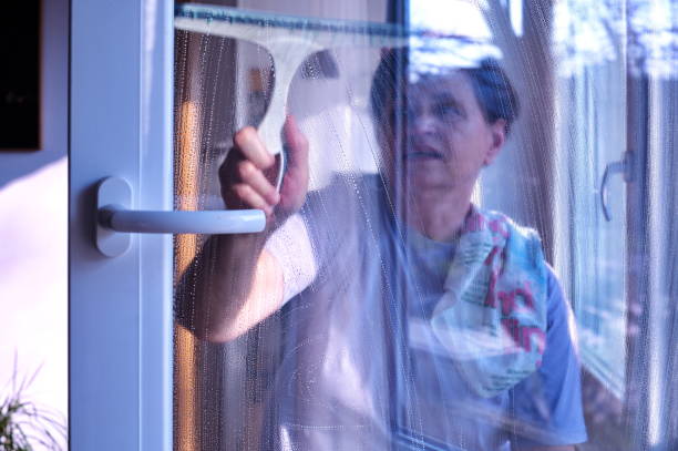istock Woman  cleaning windows 1498579584
