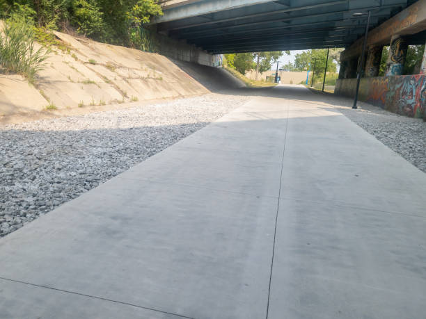 istock Concrete walking path slabs with the Lafayette Boulevard bridge visible on the Southwest Greenway in Detroit, Michigan 1498579726