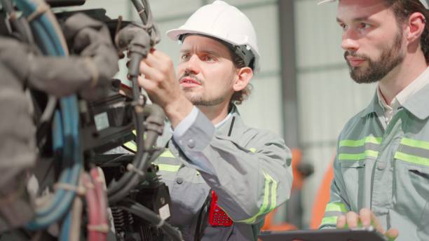 istock Maintenance engineer working with robotic arm in factory. Industry of robot programming installing for automated manufacturing technology. Mechanical engineer check the quality of the machine parts according to the program on tablet in robot manufacturing 1498581535