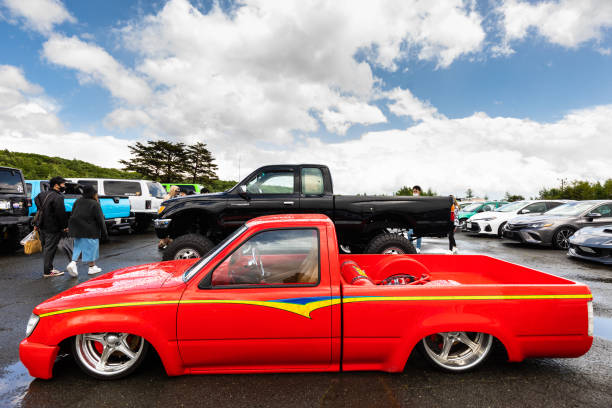06/04/2023 Shizukuishi, Iwate. Custom and classic car enthusiasts meet up in a rural car park to show off their cars and see other classic and custom cars from around Japan.