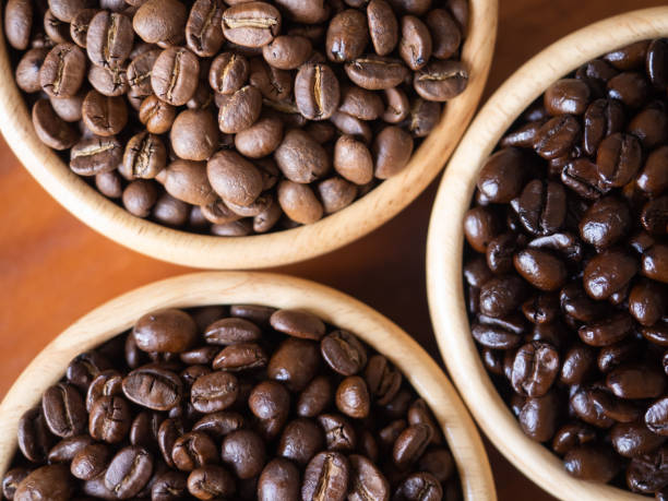 istock brown arabica coffee bean roast 3 level medium to dark different taste seed caffeine espresso drink food cafe beverage Chiang Rai, Thailand coffee on wooden table background top view selected focus 1498584459