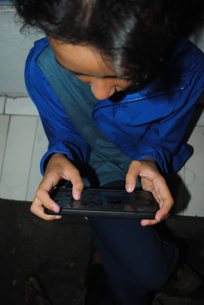 istock Little kid is holding a smart phone. 1498584512