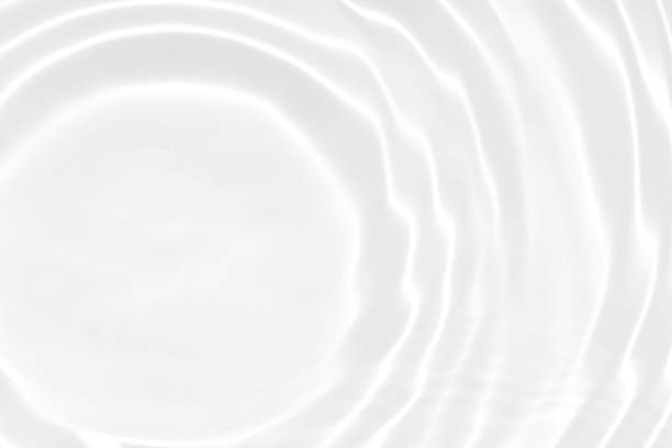 istock White water with ripples on the surface. Defocus blurred transparent white colored clear calm water surface texture with splashes and bubbles. Water waves with shining pattern texture background. 1498585376