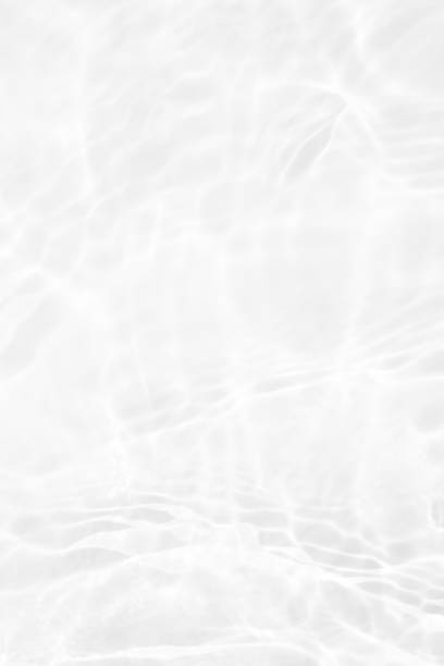 istock White water with ripples on the surface. Defocus blurred transparent white colored clear calm water surface texture with splashes and bubbles. Water waves with shining pattern texture background. 1498585485