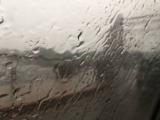 istock Window covered in water drops of a train moving through a landscape in rainfall 1498590845