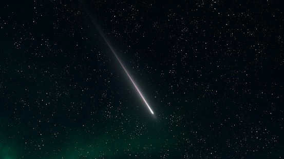 Long trail of a meteorite in the sky. Meteoroid against the background of stars. Glow of bright meteor at night.