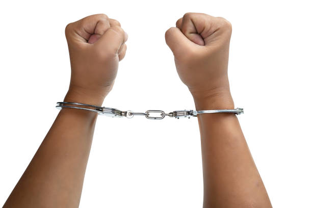 istock Arrested man with a handcuff on his hand 1498592457