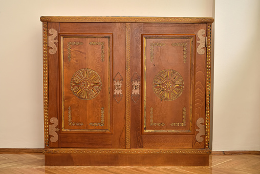 A closeup shot of a wooden wardrobe isolated on a white background