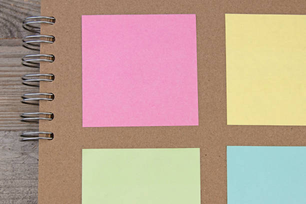 istock Coloured square paper on brown paper scrapbook 1498597568