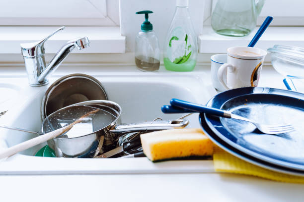 istock Pile dirty unwashed dishes in kitchen sink 1498600271