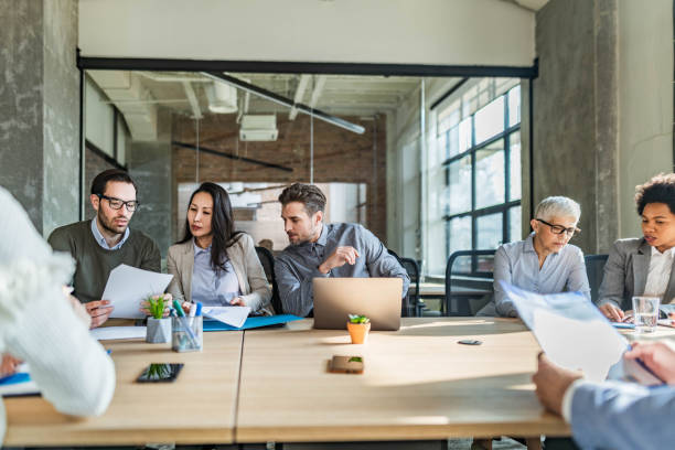 istock Group of entrepreneurs working on reports in the office. 1498602137