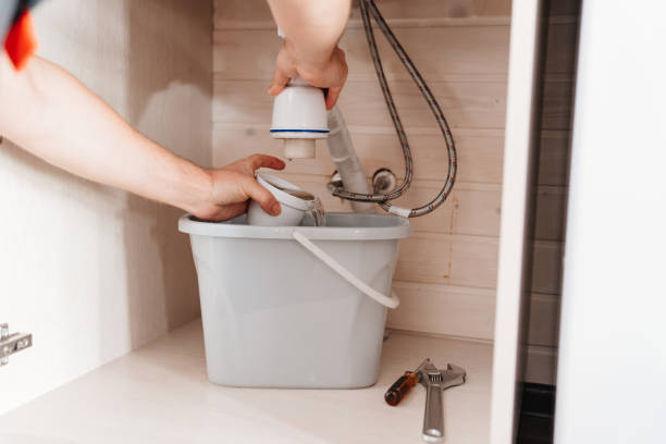 istock The plumber disassembles the siphon under the sink to clear the blockage. 1498604998