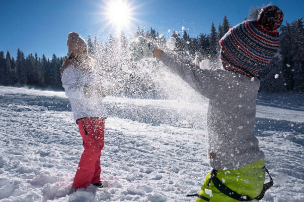 istock Happy kids having fun during winter vacation on a mountain 1498606782