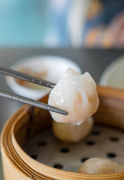 Siu Mai - Chinese steamed pork dumplings on blue plate isolated on white background.