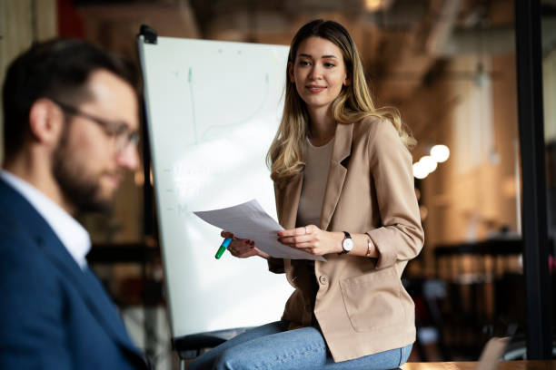 istock Businesswoman present her idea to working team. 1498608790
