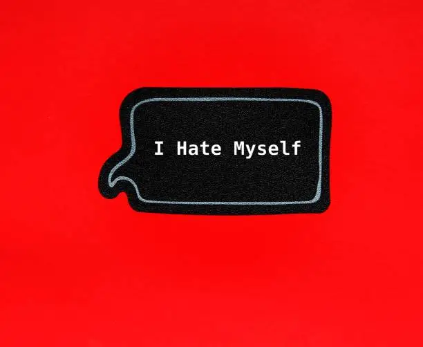 Speech sticker on red background with text I HATE MYSELF, concept of self-talk of self-hatred person, focus on negative which worsens mental health conditions such as anxiety and depression