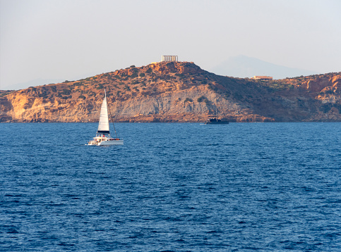 Sea view to the yacht of the  Poseidon Temple at Cape Sounion in Greece
