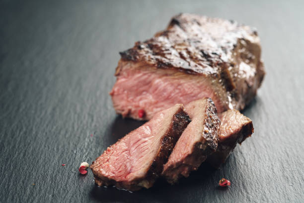 istock sliced beef steack with pepper on slate board closeup 1498613278