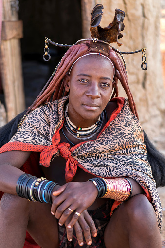 Himba woman dressed in traditional style at her village in Namibia, Africa.