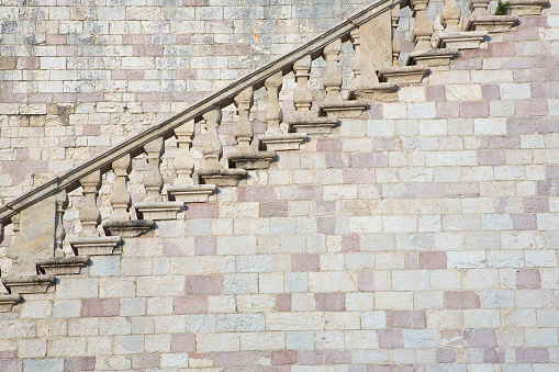 Detail of an historical and monumental old italian chiseled stone staircase with balustrade