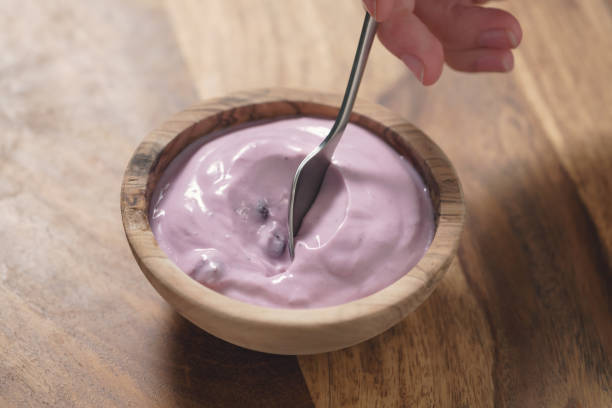 istock eating blueberry yogurt from wood bowl 1498616812