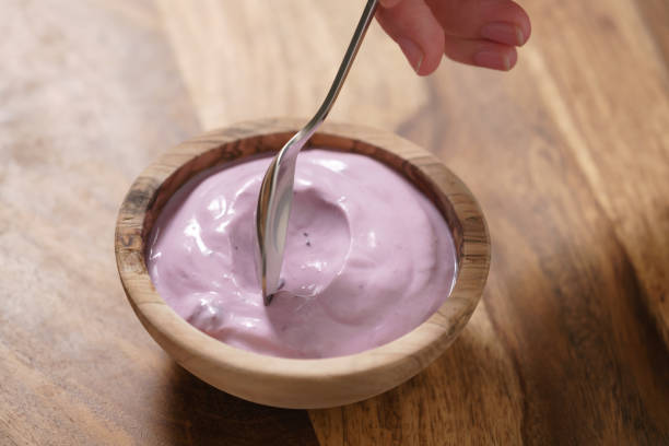 istock eating blueberry yogurt from wood bowl 1498616920