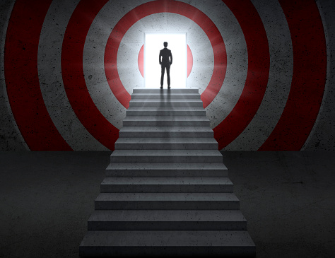 Image of empty stairs toward a red dartboard with shining target background