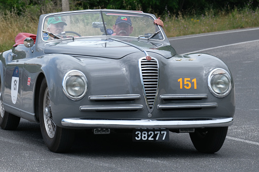 vintage racing car Mercedes-Benz 300 SL W 194 (1952) travels in the Tuscan hills during the classic car race Mille Miglia. Colle di Val d'Elsa, SI, Italy, May 17, 2014