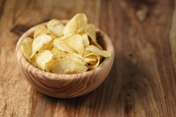 istock natural potato chips with black pepper in wood bowl on table with copy space 1498619837