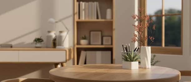 istock Copy space on a wooden round table with decor in a minimalist home office 1498619902