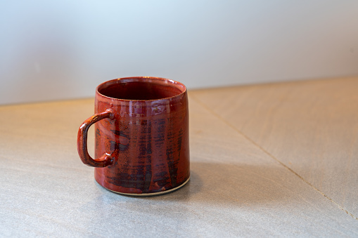 Handmade ceramic mug on a grey kitchen counter