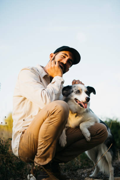 istock Young man with his dog at countryside 1498619982