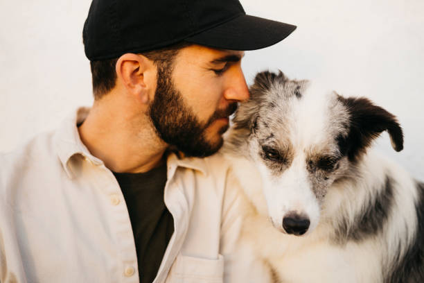 istock Young man with his dog at countryside 1498620025