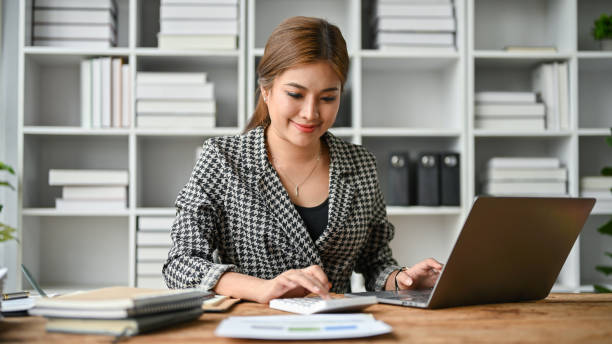 istock A beautiful Asian businesswoman using a calculator and working on her work on her laptop 1498621952