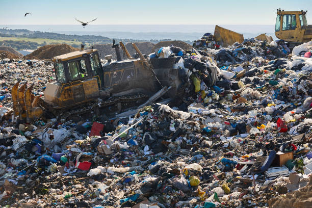 istock Heavy machinery shredding garbage in an open air landfill. Pollution 1498623335