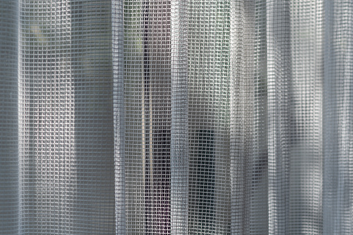 Sun light shines through transparent curtain.