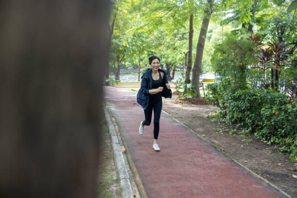 istock Asian woman exercise and running in a community garden 1498623849