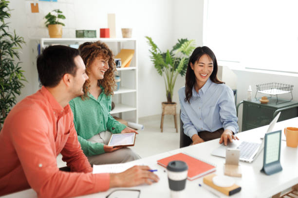 istock Smiling colleagues working together at office 1498624168