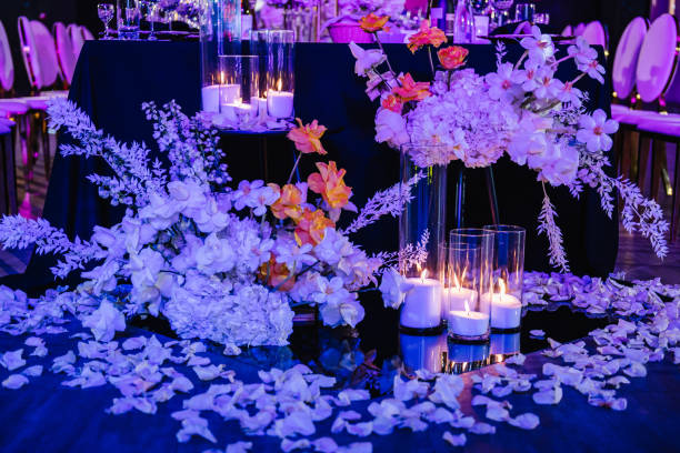 istock Composition flowers, candles, candlesticks on floor hall restaurant. Table setting, setup. Trendy decor. Birthday, baptism, event. Golden rich interior with light in night. Luxury wedding reception. 1498624319