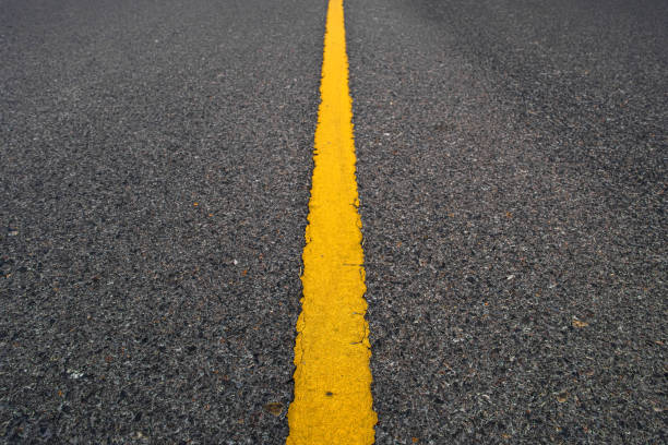 istock Texture road surface  have with yellow lines dividing traffic. 1498624546