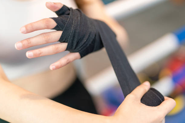 istock Asian Female Boxer doing hand wrap in a boxing gym before boxing exercise 1498631817