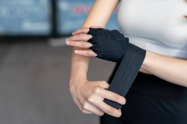 istock Asian Female Boxer doing hand wrap in a boxing gym before boxing exercise 1498632126