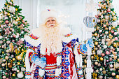 portrait of Father Frost in traditional costume with stick staff.