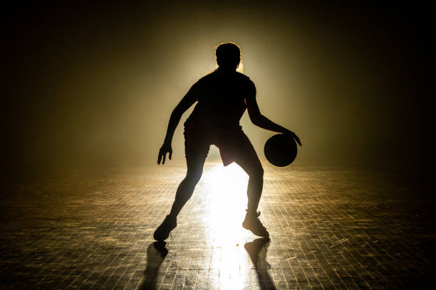 istock Basketball player dribbling ball 1498634460
