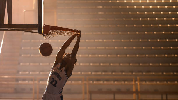 istock Basketball player dunking basketball 1498634469