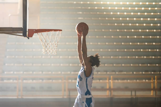 istock Basketball player dunking basketball 1498634471