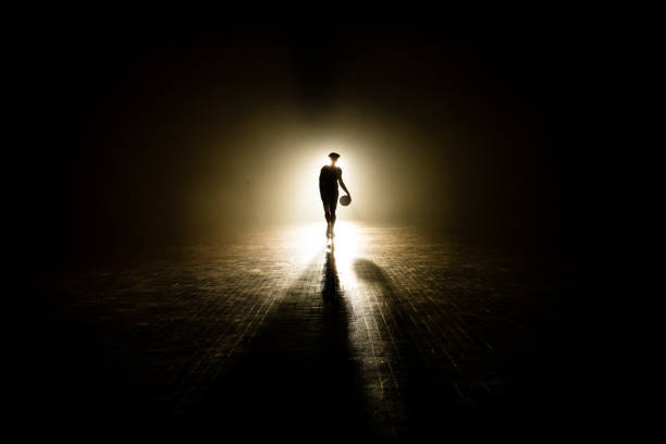 istock Basketball player walking on court 1498634472